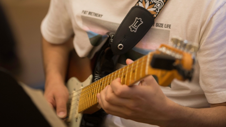 Guitarists practice in between Guitar Ensemble rehearsals