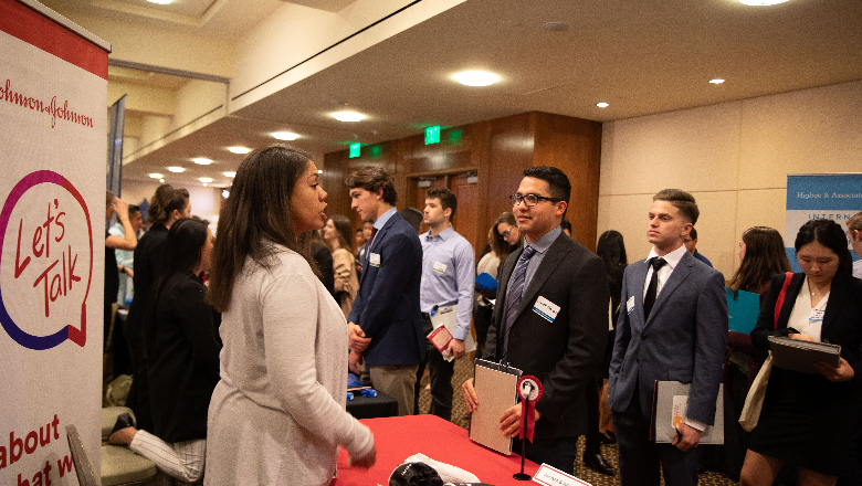 Students line up at a Johnson & Johnson booth at Career Fair