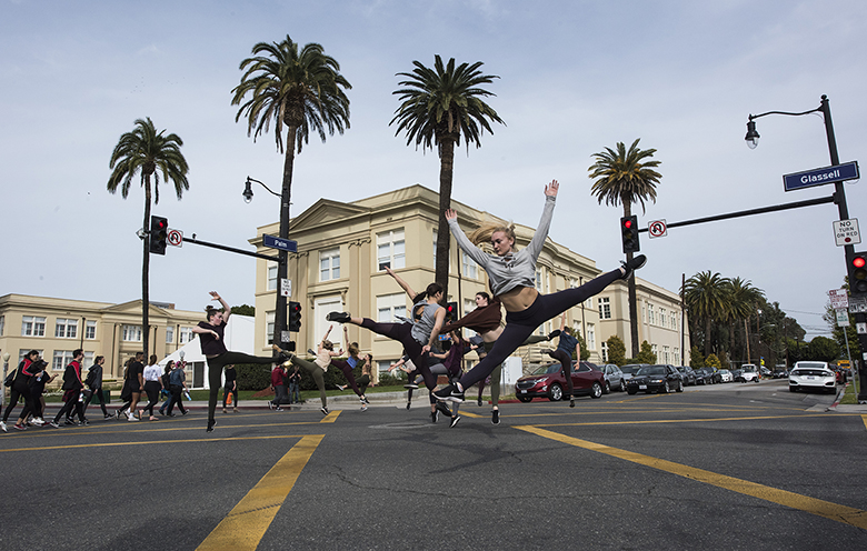 Chapman students dancing in the crosswalk of a busy intersection