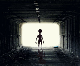 alien silhouette walking through a tunnel 
