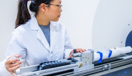 A student operating complex machinery.