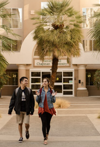 Students walk on the sunny campus at Chapman Universe in California.