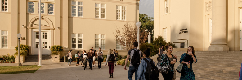 Chapman Student walking in front of Memorial Hall