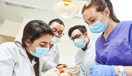 Dental students working on a patient
