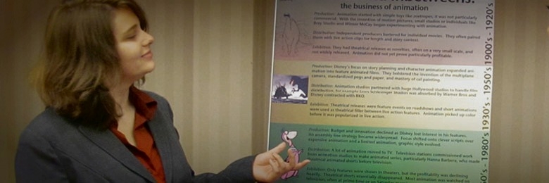 A Chapman student explains her scholarly poster to a visitor.