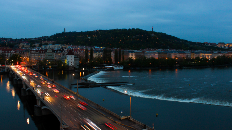 Cityscape and bridge near water at dusk