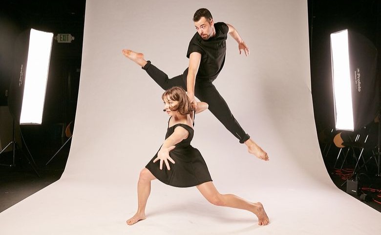 Dancers performing acrobatic moves in a studio