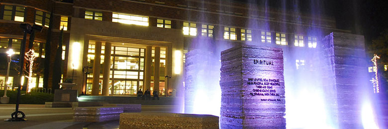 Chapman's Attallah Piazza fountain at night highlighted by neon purple lights