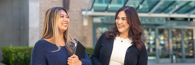 student and staff speaking and walking