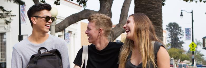 Chapman University students laugh and walk around campus