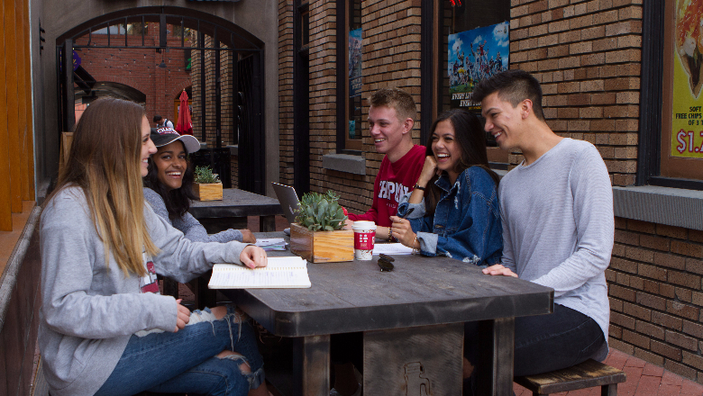 Chapman University students sitting outside a restaurant in Old Towne Orange, CA