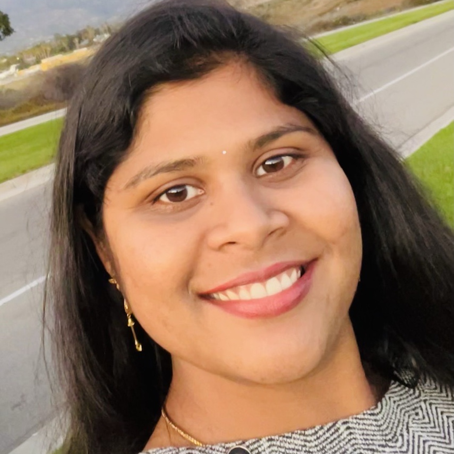Rupa Kiranmye Dundigalla's headshot against a neutral background.