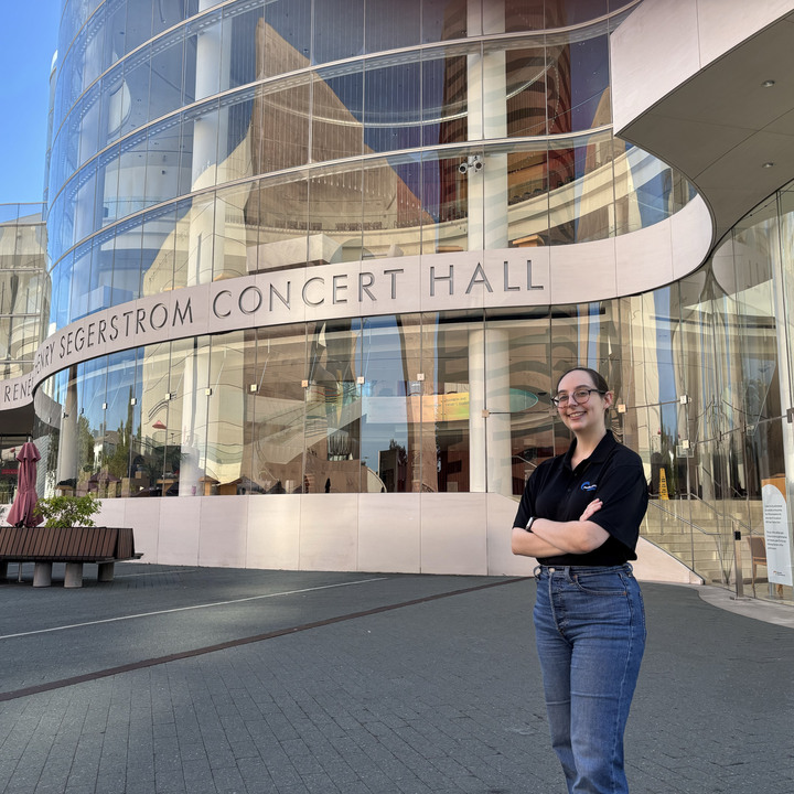 Kelly in front of the performance hall where she works