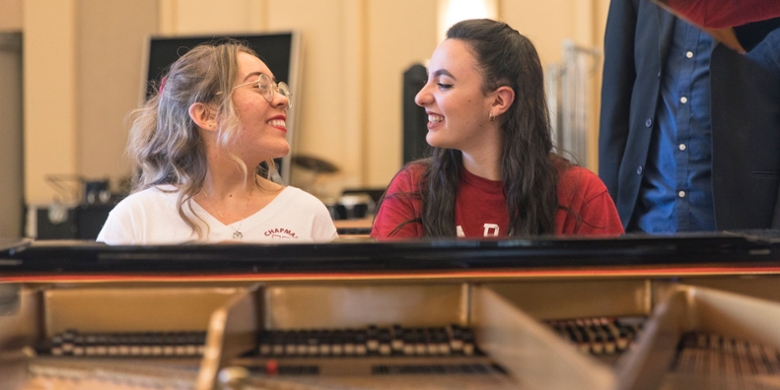 Two Chapman University students playing piano