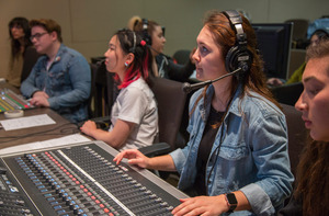 Students working in a music production space.