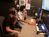students sitting at a piano