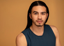 male with long brown hair and goatee wearing an olive-green tank top