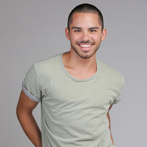 smiling man with short-cropped dark hair.