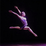 Sydney Centeno dancing on a dark stage.