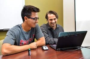 Students working on a laptop.
