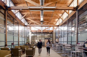 Two people walking through an open study space in Crean Hall.