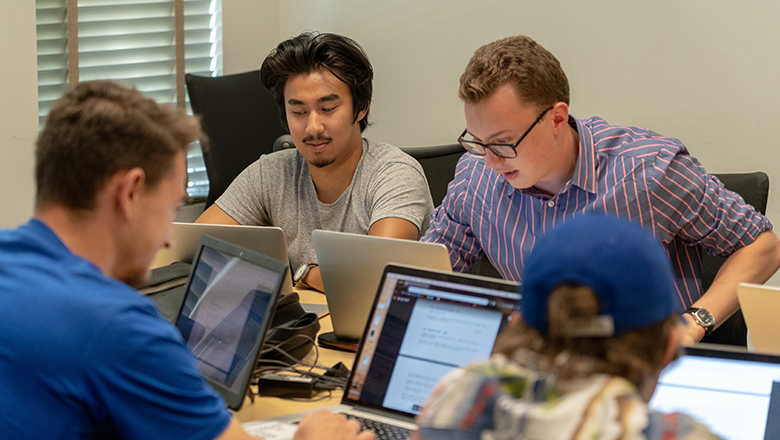 Students working on screenplays in a screenwriting class