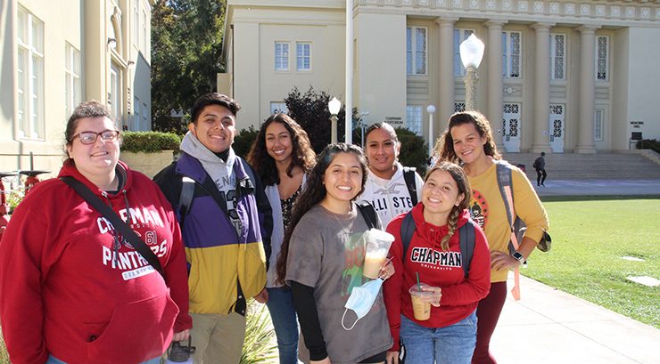 Chapman students standing in front of Chapman's Memorial Hall