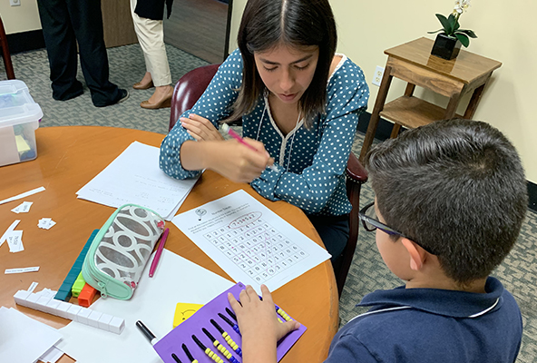 Chapman student tutoring a boy in math