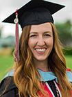 Kylee Moore, Woman smiling wearing a graduation cap and gown