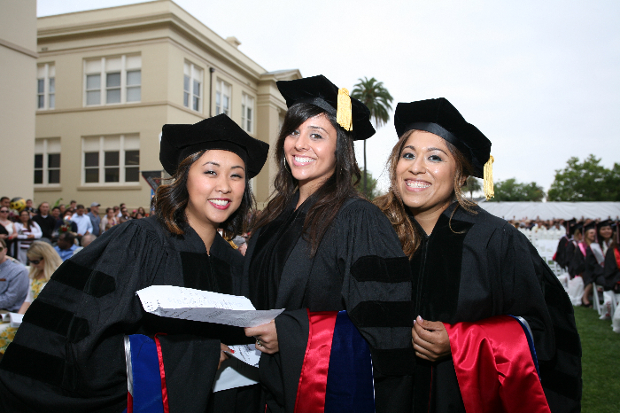 Chapman University graduates pose at commencement ceremony in their regalia