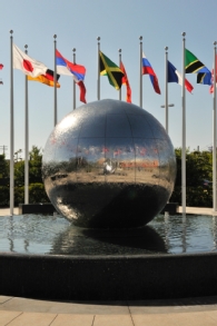 Global Education Fountain on Chapman campus with flags from different countries in background.