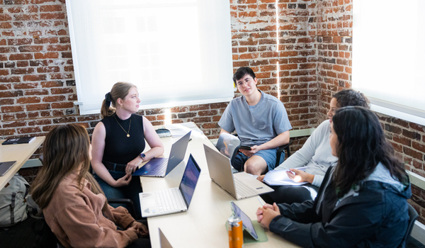 Five students in class working together.