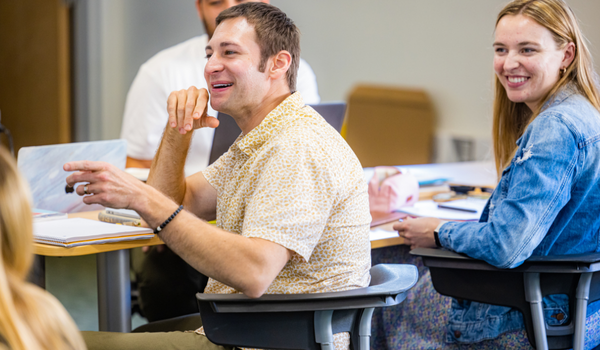 Student in class discussing curriculum.