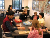 FAST intern sitting with students at a table