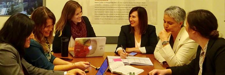 Group of people at conference table.