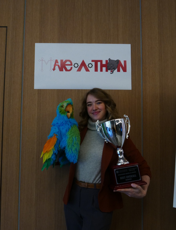 Chloe Leis holding Best Overall winner trophy