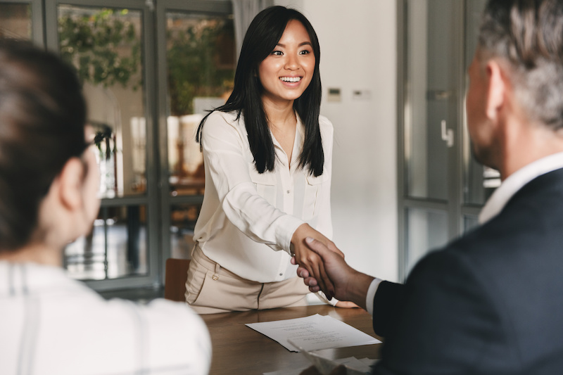 Woman shaking hands with man for job offer