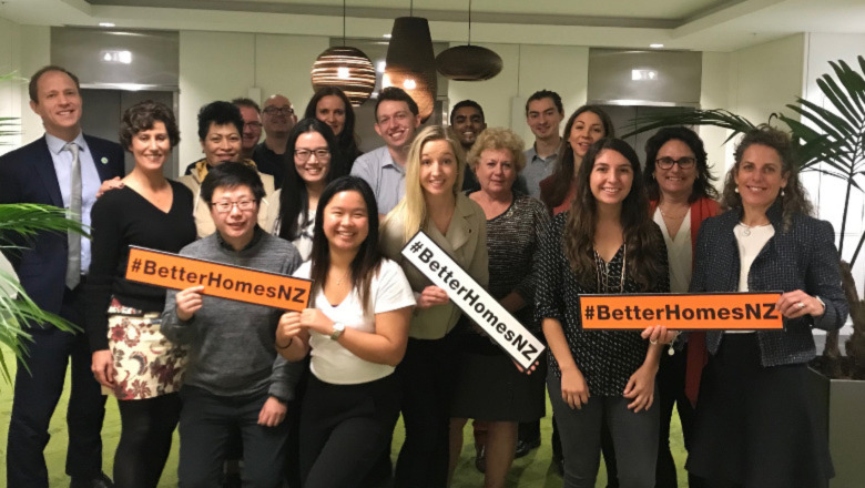 Colleagues with signs that say Better Homes NZ