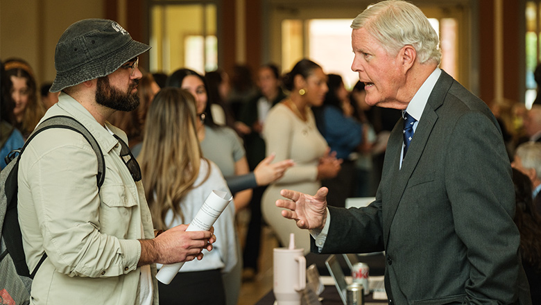 A Fowler Professor in discussion with a student