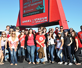 group of students in front of Anaheim Angels sign