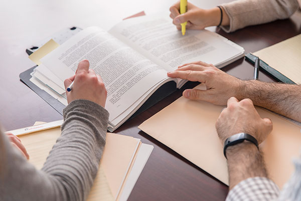 People's hands on tax paperwork