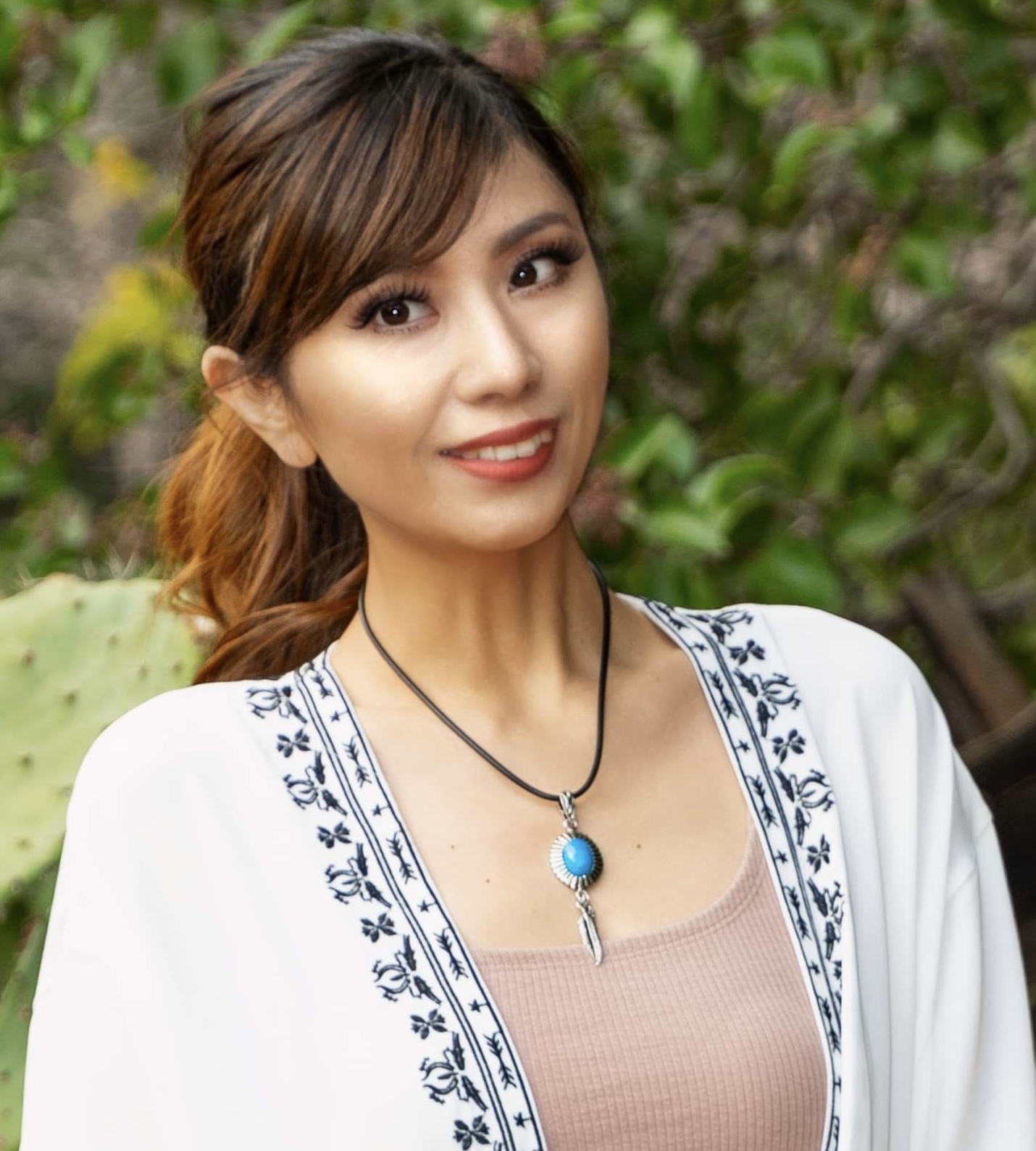 Woman with brown hair and white shirt