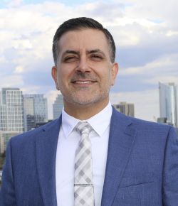 Man in blue suit with white shirt and tie