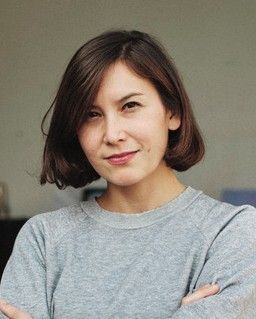 Woman with short brown hair, gray shirt 