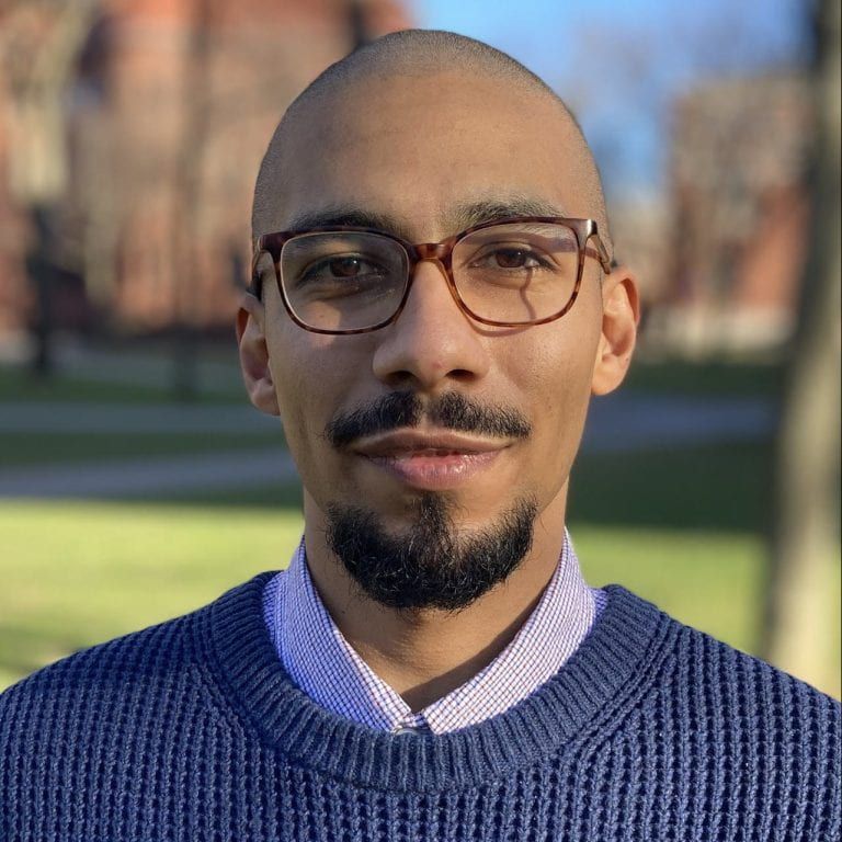 Male with glasses and a blue sweater