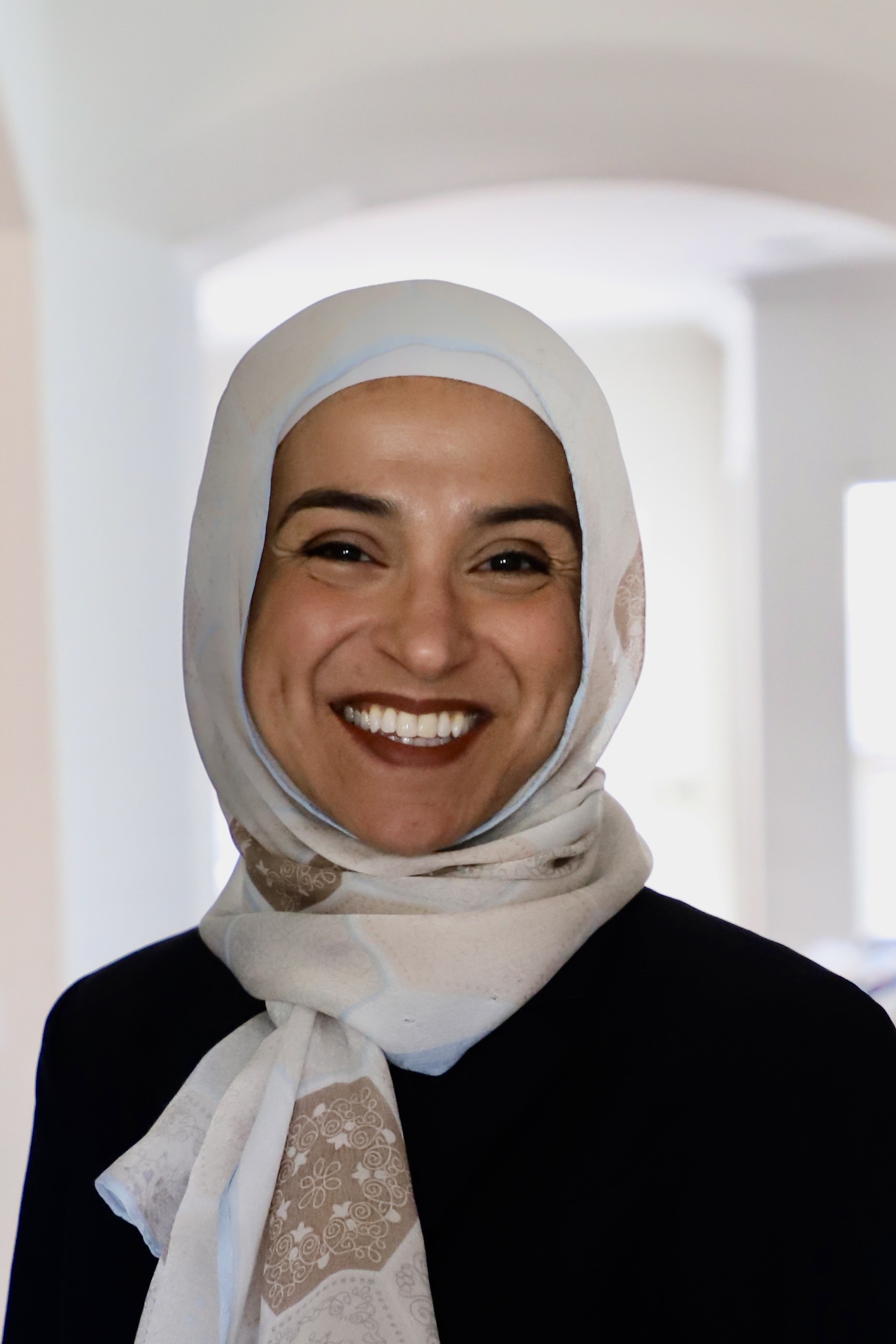 Woman with white headscarf and black shirt