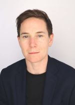 woman in glasses with short hair and a blue shirt