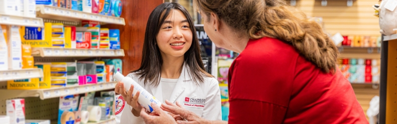 student shows patient a bottle of pills