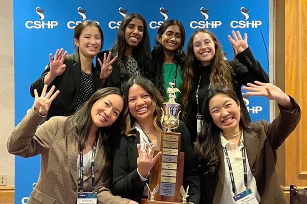 CUSP students hold up trophy