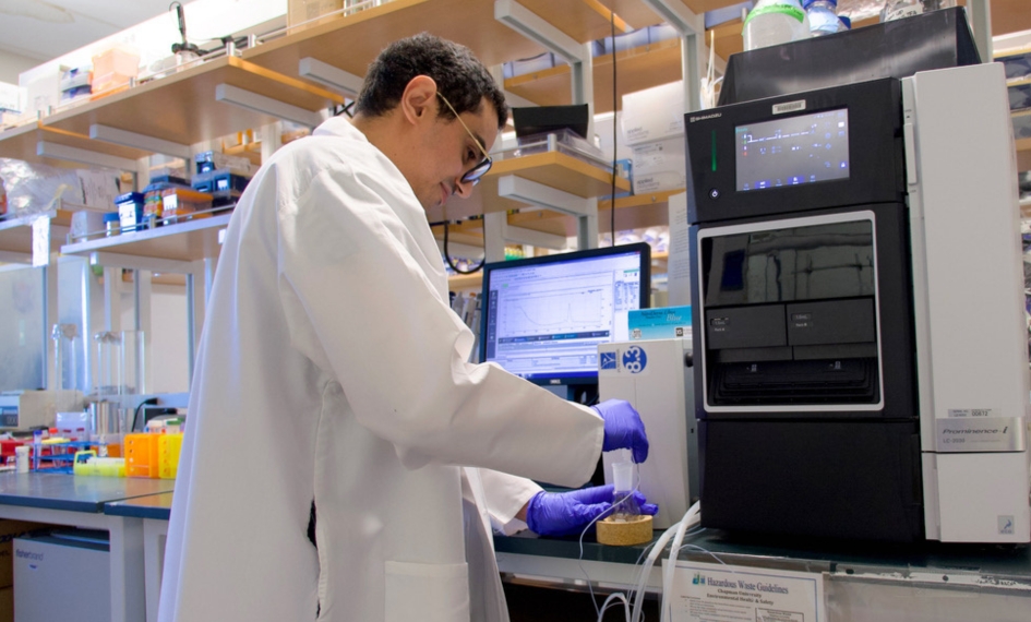 Student works with lab equipment
